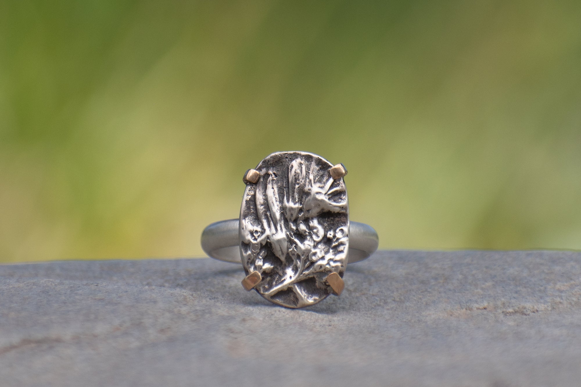 Nature-inspired Oval Wild Meadow Ring in oxidized sterling silver and 14k gold with wildflower and botanical textures from harebell buds and goldenrod.