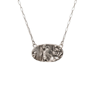 Nature-inspired Wild Meadow Necklace in oxidized sterling silver with layered wildflower and botanical textures from harebell buds, goldenrod and overlapping leaves.
