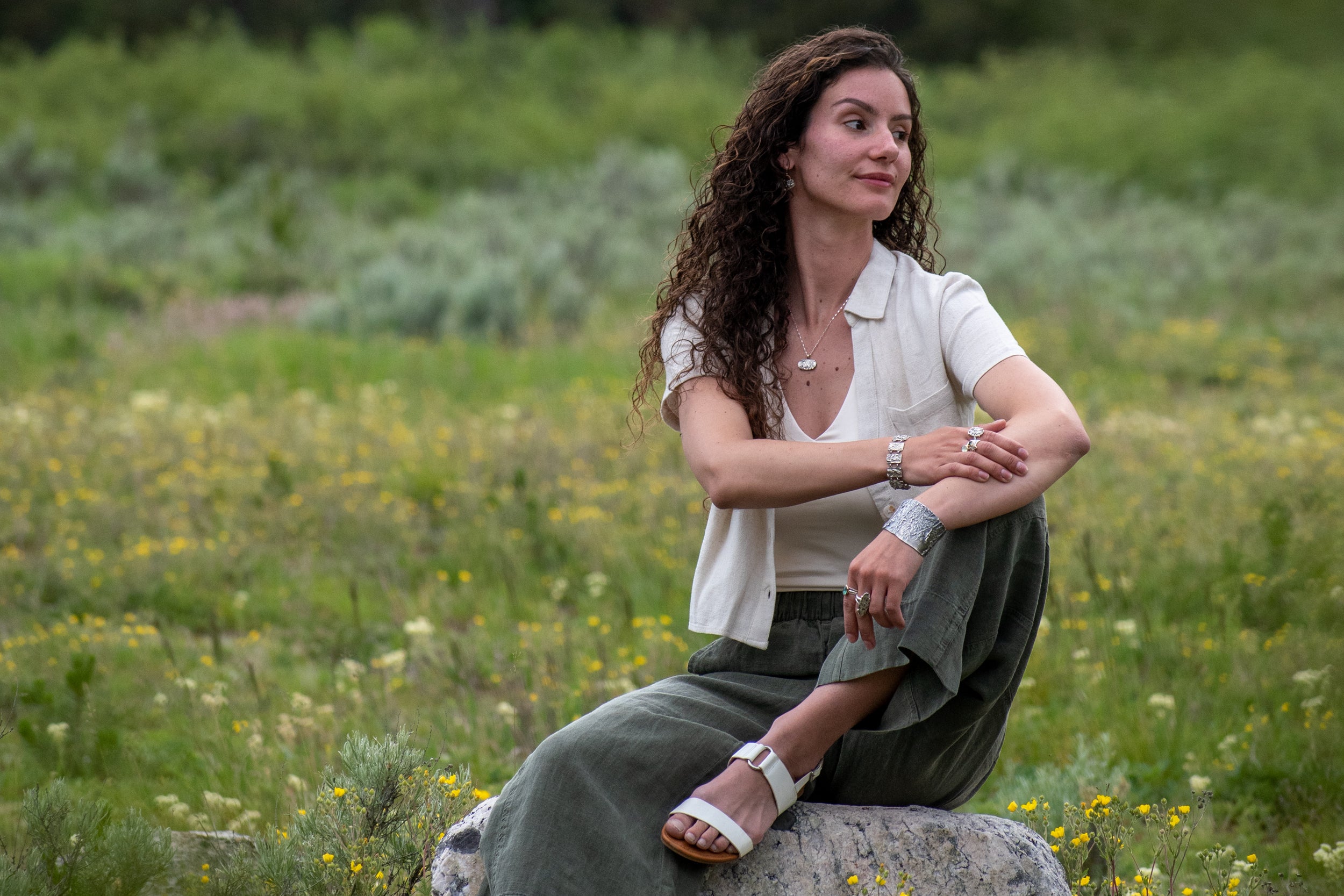 model wearing Nature-inspired Horizontal Wild Meadow Necklace in oxidized sterling silver and 14k gold with wildflower and botanical textures from lupine leaves and late-summer sagebrush buds.