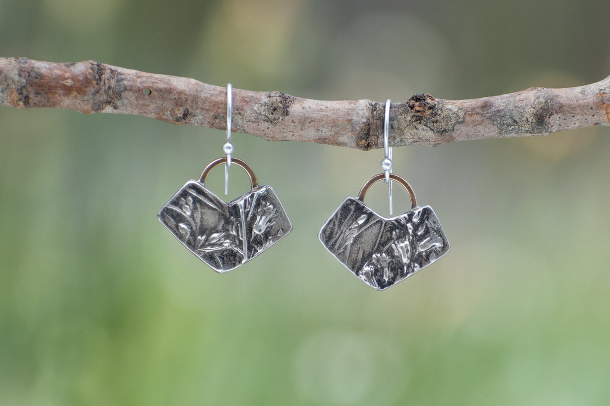 Wild Meadow Earrings in sterling silver with Spreading Groundsmoke and goldenrod botanical textures and 14k gold setting-sun arcs.