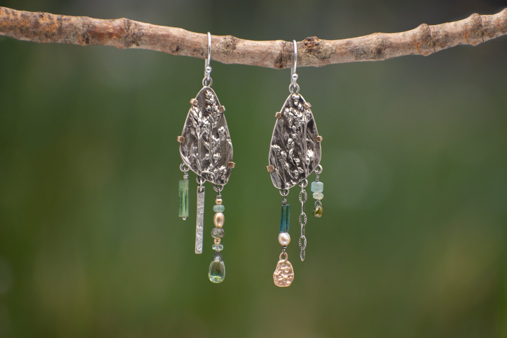 Wild Meadow Wing Earrings in sterling silver and 14k gold with lupine, goldenrod and sage botanical textures, dangling tourmaline, kyanite, aquamarine, green garnet, green diamond and freshwater pearl gemstones.