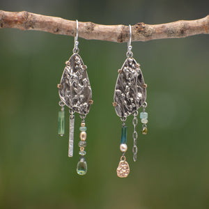 Wild Meadow Wing Earrings in sterling silver and 14k gold with lupine, goldenrod and sage botanical textures, dangling tourmaline, kyanite, aquamarine, green garnet, green diamond and freshwater pearl gemstones.