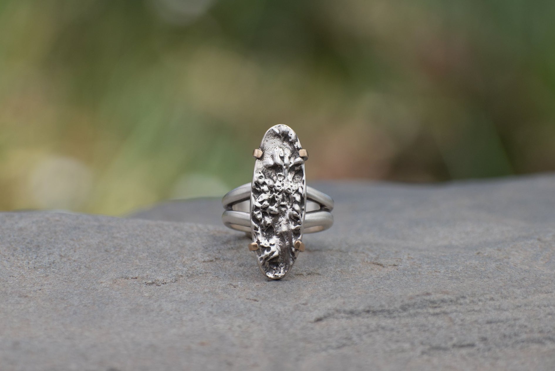 Nature-inspired Wild Meadow Texture Ring in oxidized sterling silver and 14k gold with layered wildflower and botanical textures from goldenrod and an overlapping leaf.