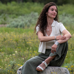 model wearing Nature-inspired Wild Meadow Cuff in oxidized sterling silver with layered wildflower and botanical textures from lupine, late-summer sagebrush, goldenrod and wild grasses.