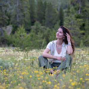 model wearing Nature-inspired Wild Meadow Texture Necklace in sterling silver with layered wildflower and botanical textures from lupine petals, goldenrod, sage leaves and wild grasses.