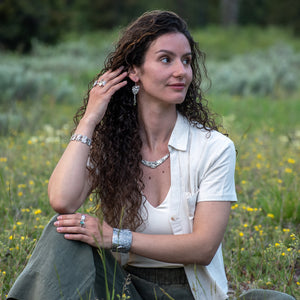 model wearing Nature-inspired Wild Meadow Texture Necklace in sterling silver with layered wildflower and botanical textures from lupine petals, goldenrod, sage leaves and wild grasses.