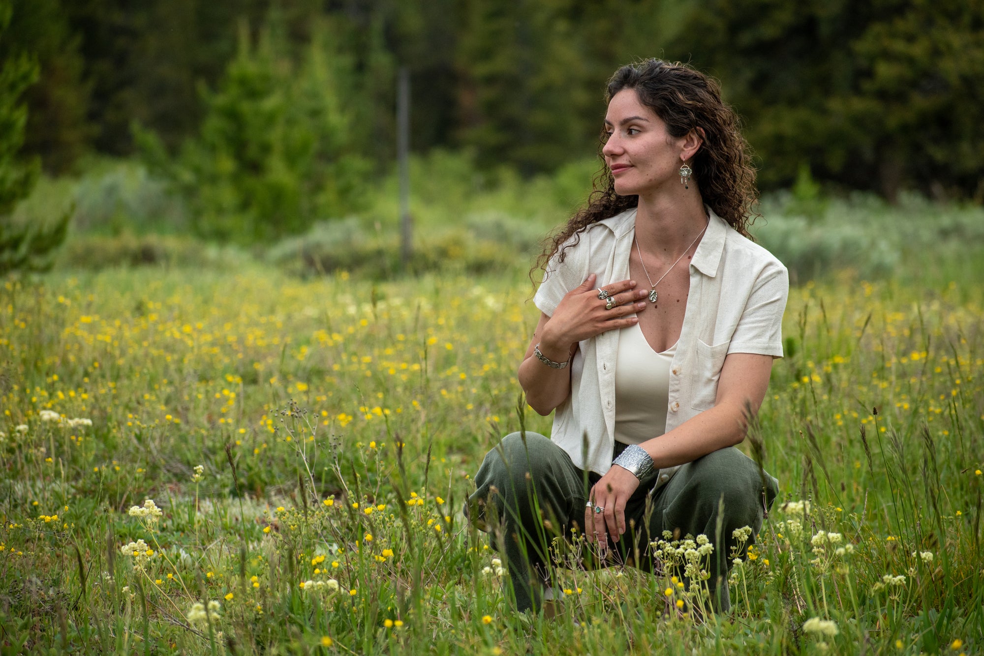 model wearing Nature-inspired Oval Wild Meadow Necklace in sterling silver and 14k gold with harebell bud and leaf botanical textures inspired by wildflowers and meadow plants.