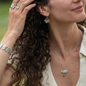 model waring Nature-inspired Oval Wild Meadow Ring in oxidized sterling silver and 14k gold with wildflower and botanical textures from harebell buds and goldenrod.