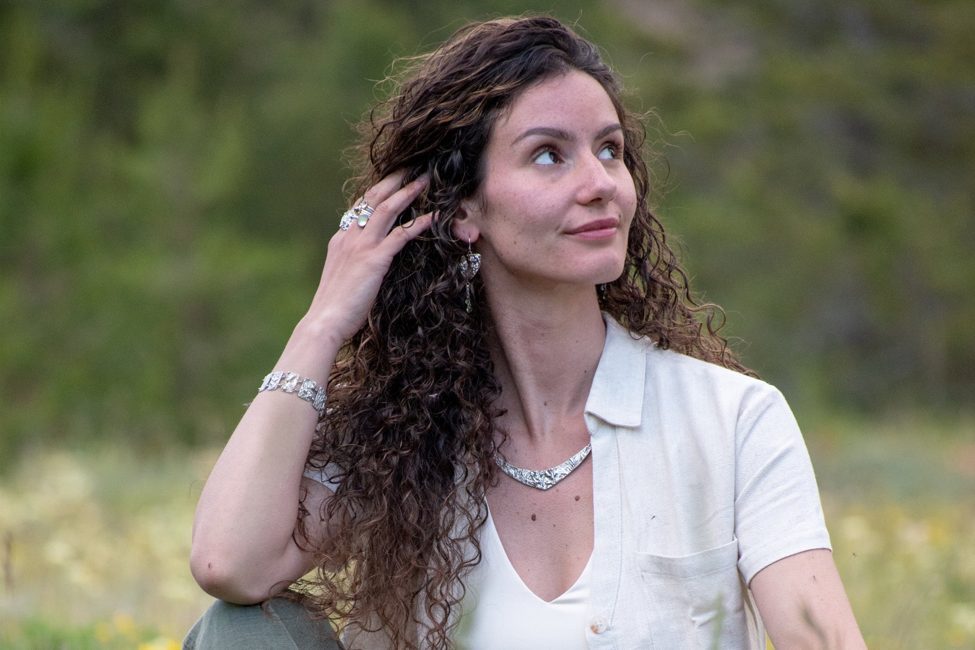 model wearing Nature-inspired Wild Meadow Texture Necklace in sterling silver with layered wildflower and botanical textures from lupine petals, goldenrod, sage leaves and wild grasses.