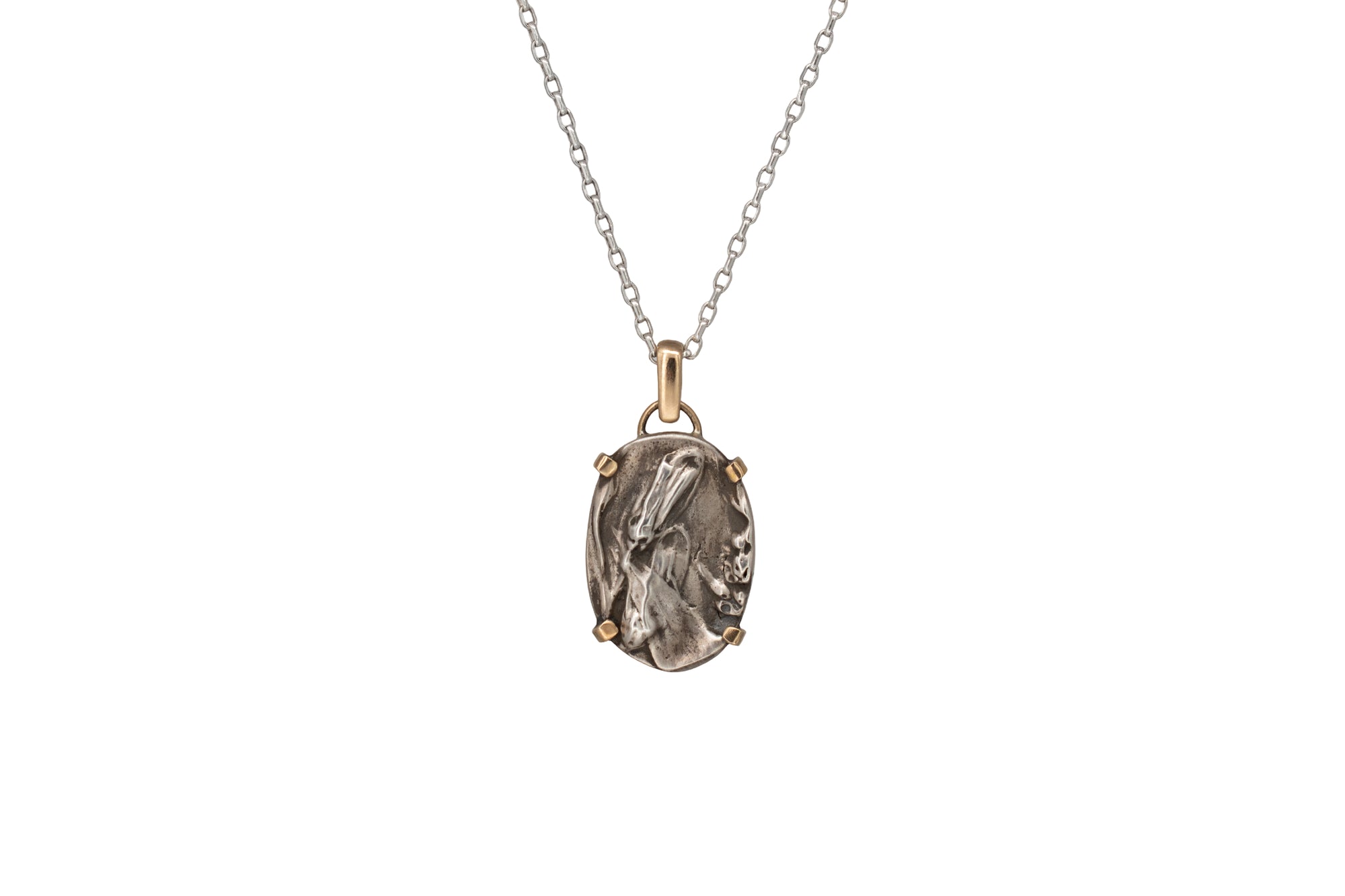 Nature-inspired Oval Wild Meadow Necklace in sterling silver and 14k gold with harebell bud and leaf botanical textures inspired by wildflowers and meadow plants.