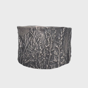 Nature-inspired Wild Meadow Cuff in oxidized sterling silver with layered wildflower and botanical textures from lupine, late-summer sagebrush, goldenrod and wild grasses.