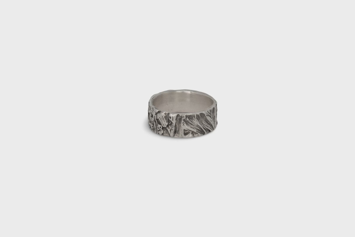 Nature-inspired Wild Meadow Ring Band in oxidized sterling silver with layered wildflower and botanical textures from budding sage, sage leaves and goldenrod.