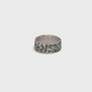 Nature-inspired Wild Meadow Ring Band in oxidized sterling silver with layered wildflower and botanical textures from budding sage, sage leaves and goldenrod.