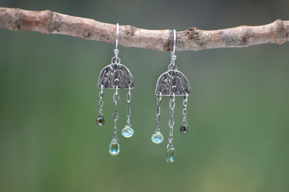 Wild Meadow Rain Earrings in sterling silver with late-summer sage botanical textures, dangling silver chains and green diamond, kyanite and green garnet gemstones.
