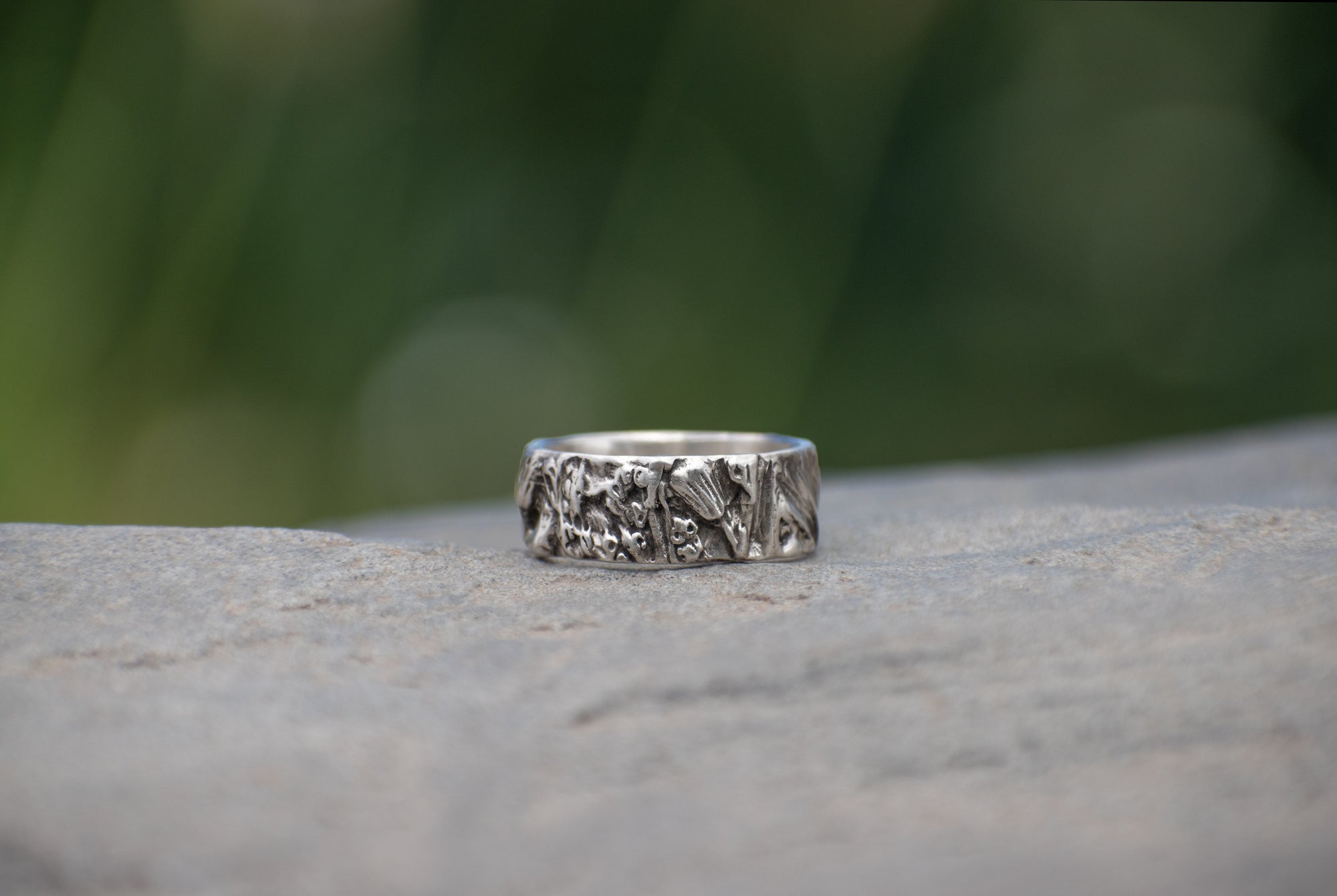 Nature-inspired Wild Meadow Ring Band in oxidized sterling silver with layered wildflower and botanical textures from budding sage, sage leaves and goldenrod.