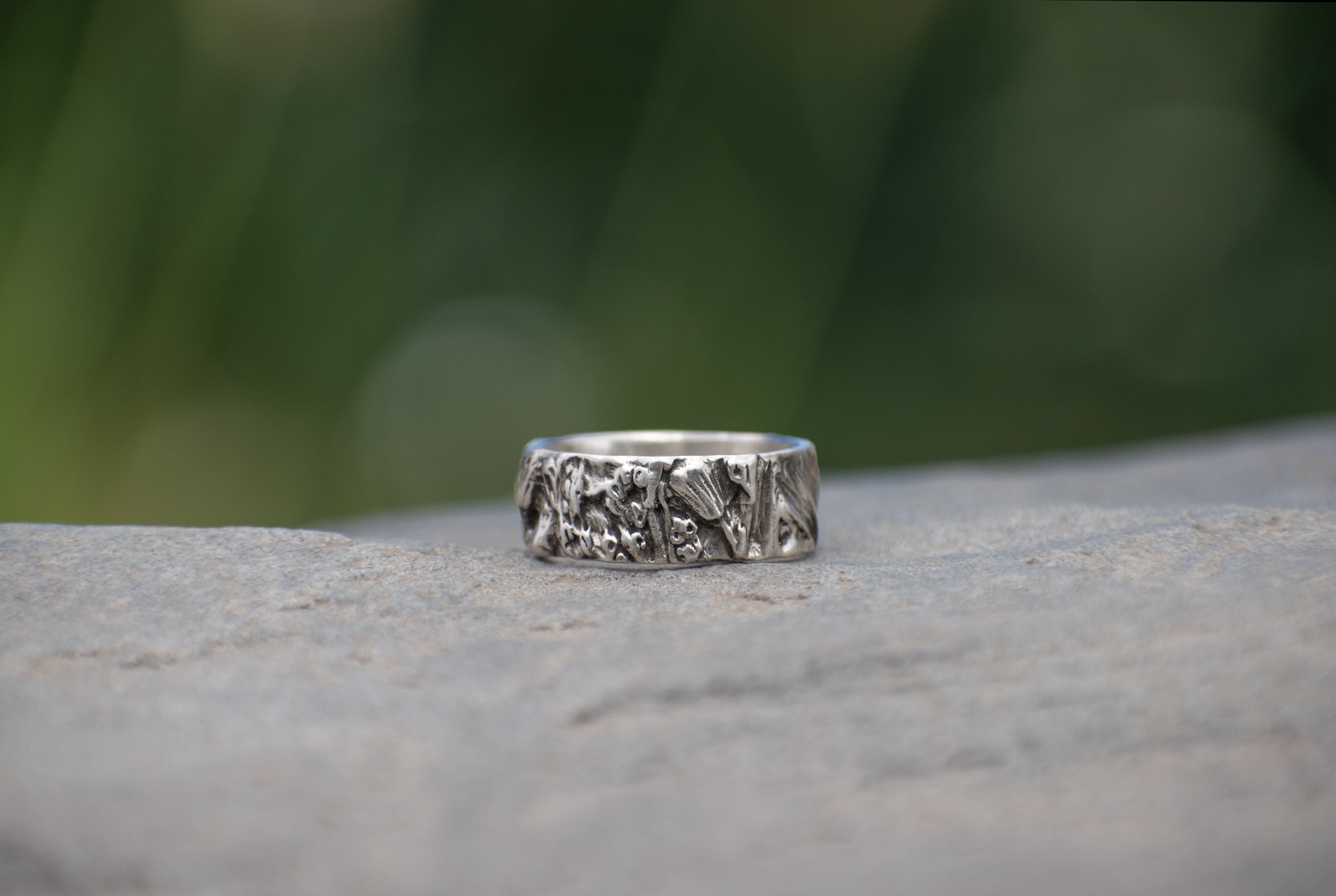 Nature-inspired Wild Meadow Ring Band in oxidized sterling silver with layered wildflower and botanical textures from budding sage, sage leaves and goldenrod.