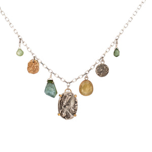 Nature-inspired Wild Meadow Charm Necklace in sterling silver and 14k gold with wildflower botanical textures, green sapphire, tourmaline, kyanite and green garnet gemstones.