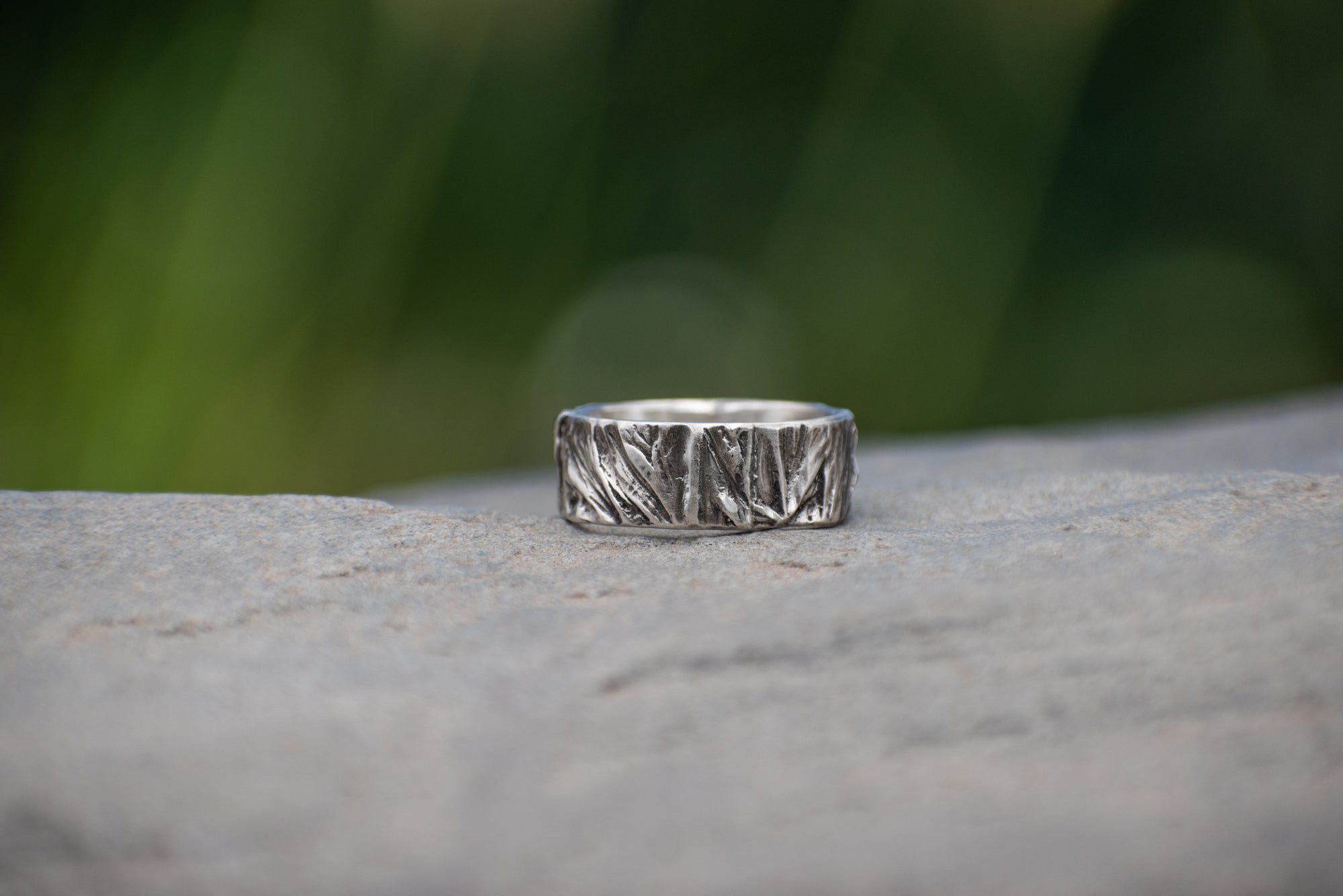 Nature-inspired Wild Meadow Ring Band in oxidized sterling silver with layered wildflower and botanical textures from budding sage, sage leaves and goldenrod.