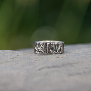 Nature-inspired Wild Meadow Ring Band in oxidized sterling silver with layered wildflower and botanical textures from budding sage, sage leaves and goldenrod.