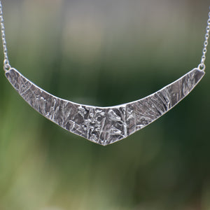 Nature-inspired Wild Meadow Texture Necklace in sterling silver with layered wildflower and botanical textures from lupine petals, goldenrod, sage leaves and wild grasses.