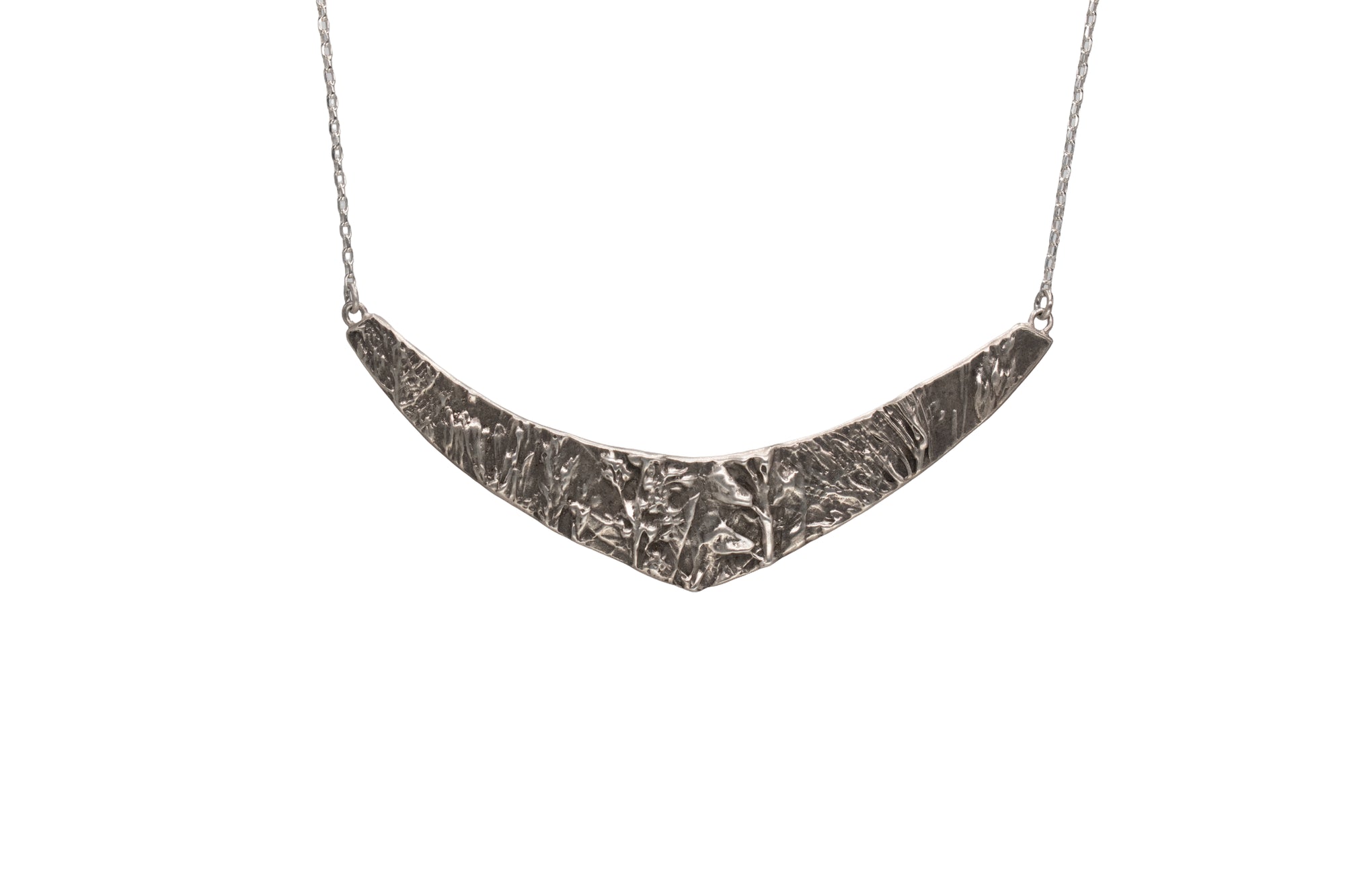 Nature-inspired Wild Meadow Texture Necklace in sterling silver with layered wildflower and botanical textures from lupine petals, goldenrod, sage leaves and wild grasses.