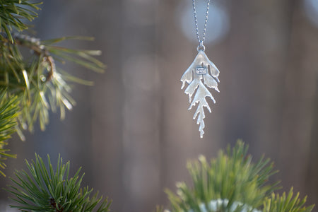 Back of handmade silver cedar necklace