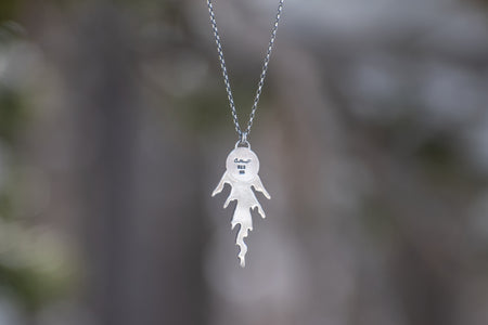 Back of sterling silver cedar necklace with green rutilated quartz set in 14k gold