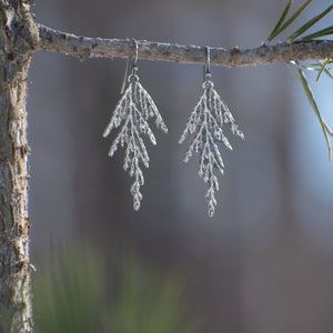 Handmade sterling silver cedar dangle earrings on branch