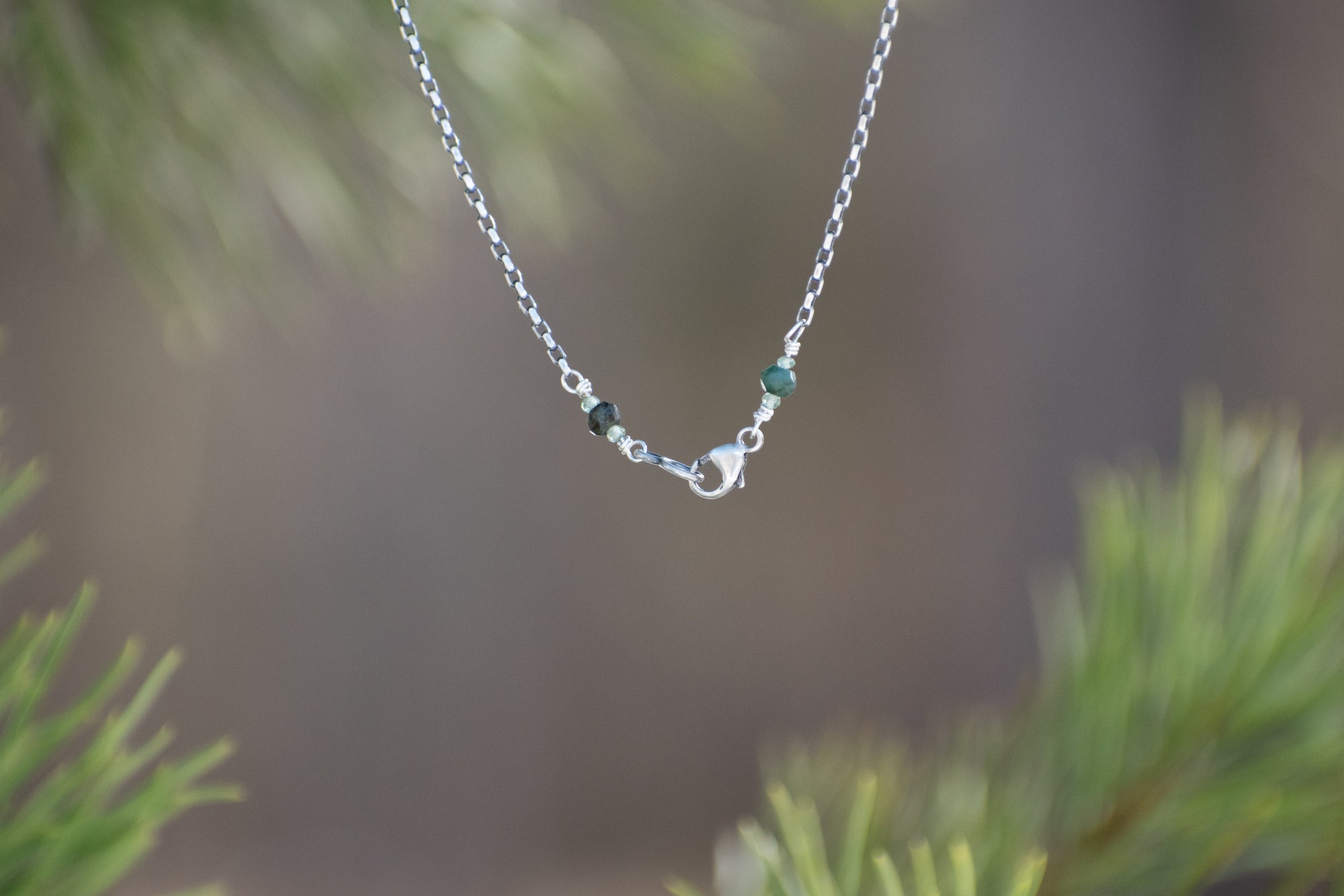 Silver lobster clasp with emerald beads on silver chain necklace