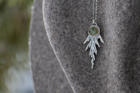 Handmade sterling silver cedar necklace with green gemstone set in 14k gold