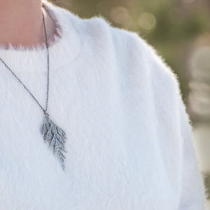 Woman wearing handmade sterling silver cedar necklace