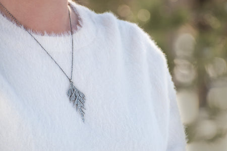 Woman wearing handmade sterling silver cedar necklace